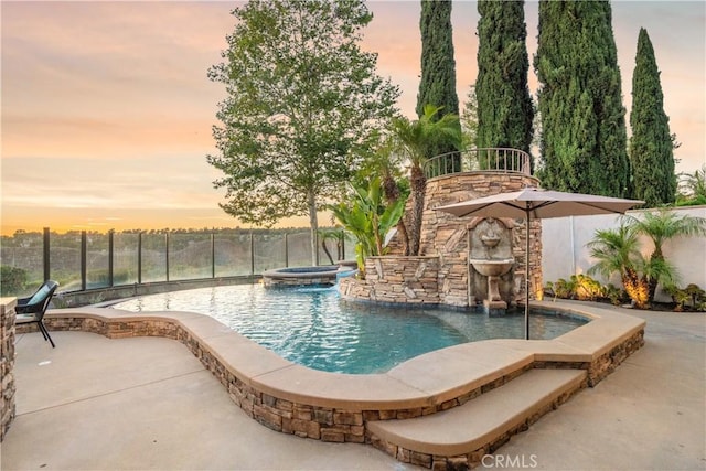 25 Thalia St, Ladera Ranch, CA 92694 - pool at dusk with a fenced backyard, a patio area, and a pool with connected hot tub