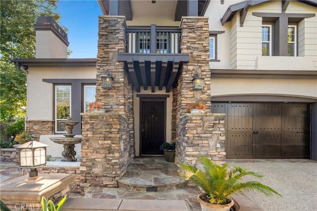 25 Thalia St, Ladera Ranch, CA 92694 - property entrance with a balcony, stucco siding, a garage, and stone siding
