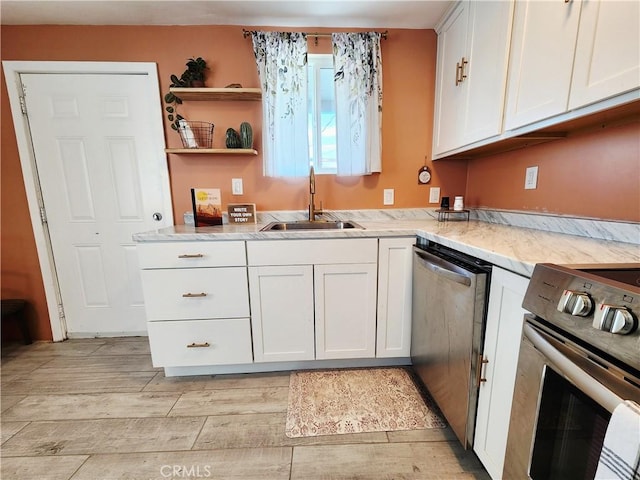 65076 E Broadway, Joshua Tree, CA 92252 - kitchen with appliances with stainless steel finishes, white cabinets, light wood finished floors, and light stone counters