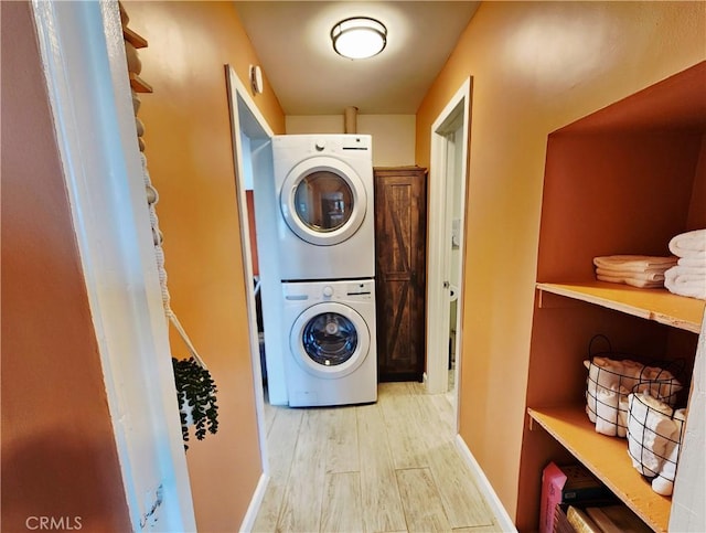 65076 E Broadway, Joshua Tree, CA 92252 - washroom featuring estacked washer and dryer and light wood-style floors