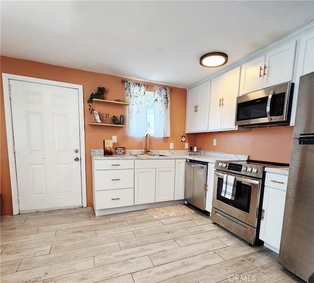 65076 E Broadway, Joshua Tree, CA 92252 - kitchen with stainless steel appliances, light countertops, and white cabinetry