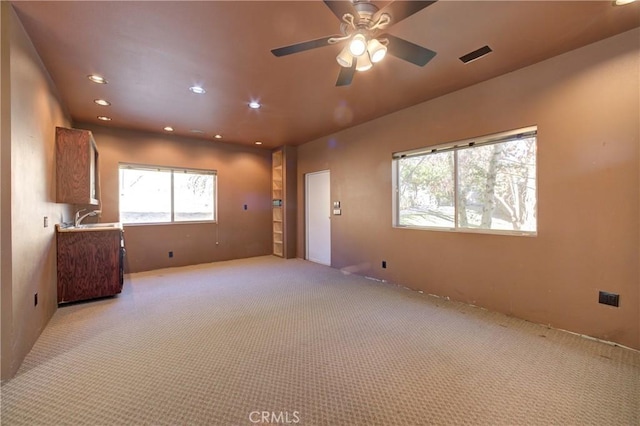 6305 Portola Rd, Atascadero, CA 93422 - unfurnished living room with light colored carpet, healthy amount of natural light, a ceiling fan, and recessed lighting