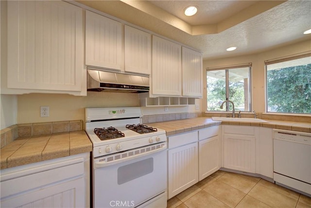6305 Portola Rd, Atascadero, CA 93422 - kitchen featuring white appliances, range hood, light tile patterned floors, white cabinetry, and a textured ceiling