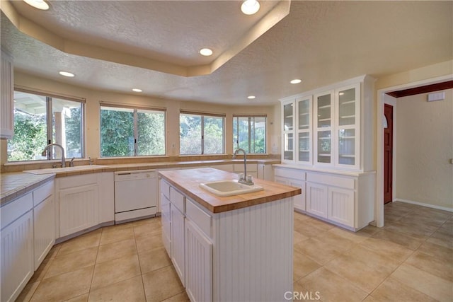 6305 Portola Rd, Atascadero, CA 93422 - kitchen with white dishwasher, a textured ceiling, wood counters, white cabinetry, and recessed lighting