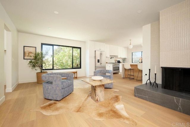 2025 Valley Rd, Oceanside, CA 92056 - living area with light wood finished floors, plenty of natural light, and a fireplace