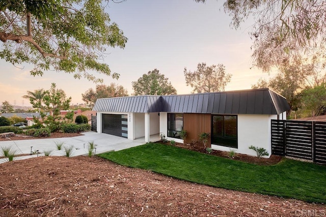 2025 Valley Rd, Oceanside, CA 92056 - view of front of house with stucco siding, driveway, a garage, a yard, and a metal roof