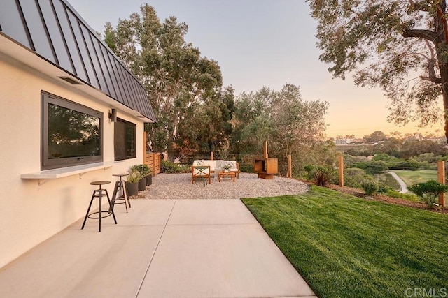 2025 Valley Rd, Oceanside, CA 92056 - patio terrace at dusk featuring a patio area, a yard, and outdoor lounge area