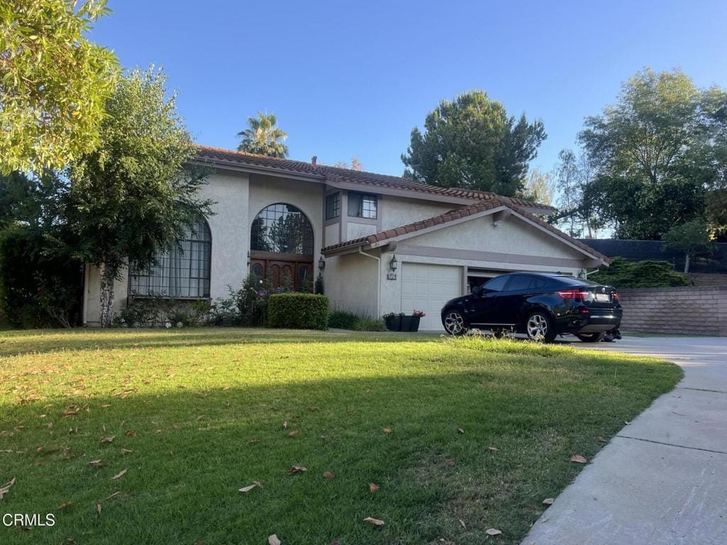 652 Stonebrook St, Simi Valley, CA 93065 - view of front of house with a garage, a front yard, and stucco siding