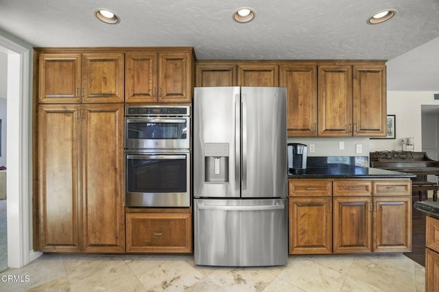2142 Klamath Dr, Camarillo, CA 93010 - kitchen with stainless steel appliances, brown cabinets, recessed lighting, and dark stone counters