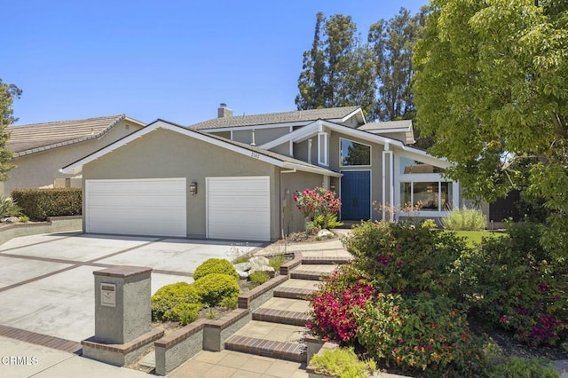2142 Klamath Dr, Camarillo, CA 93010 - view of front of house with a garage, concrete driveway, a chimney, and stucco siding