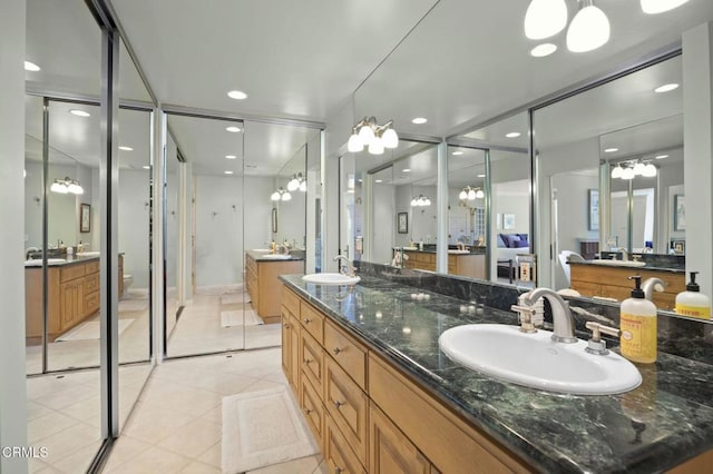 2142 Klamath Dr, Camarillo, CA 93010 - full bathroom featuring two vanities, a chandelier, recessed lighting, tile patterned floors, and a stall shower