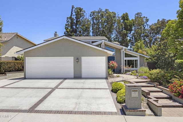 2142 Klamath Dr, Camarillo, CA 93010 - mid-century home with stucco siding, concrete driveway, a garage, and a chimney