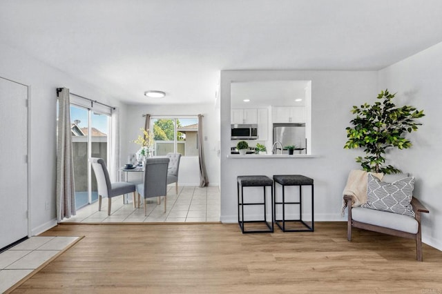 853 Dana Point Way, Oceanside, CA 92058 - dining area with light wood-style flooring and baseboards