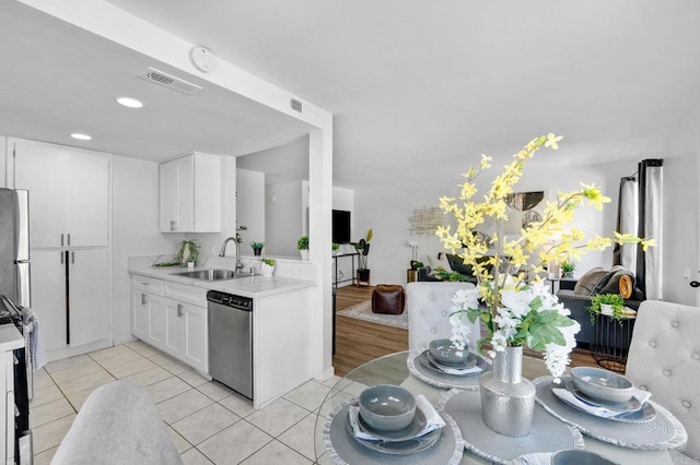 853 Dana Point Way, Oceanside, CA 92058 - kitchen featuring appliances with stainless steel finishes, light countertops, white cabinetry, light tile patterned flooring, and recessed lighting