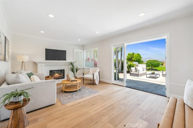 9 Phillips Cir, Laguna Niguel, CA 92677 - living room with wood finished floors, recessed lighting, and a brick fireplace