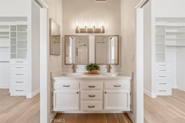 9 Phillips Cir, Laguna Niguel, CA 92677 - bathroom featuring wood finished floors, double vanity, and a spacious closet