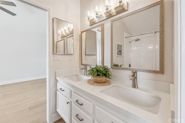 9 Phillips Cir, Laguna Niguel, CA 92677 - bathroom with double vanity, a ceiling fan, wood finished floors, and a shower