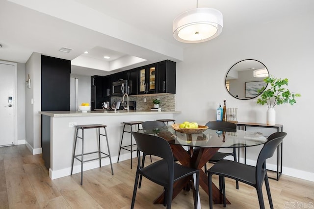183 Mangano Cir, Encinitas, CA 92024 - dining space featuring light wood finished floors, a raised ceiling, and recessed lighting