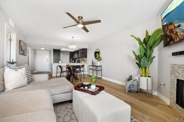 183 Mangano Cir, Encinitas, CA 92024 - living room featuring a ceiling fan, light wood-style floors, and a fireplace