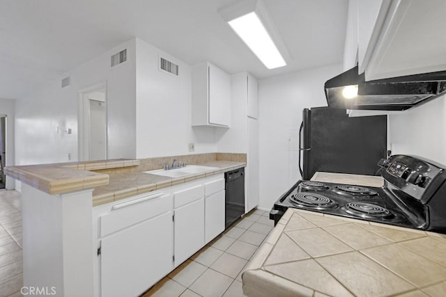 23515 Lyons Ave Unit 140, Valencia, CA 91355 - kitchen with range with electric stovetop, freestanding refrigerator, black dishwasher, and white cabinets