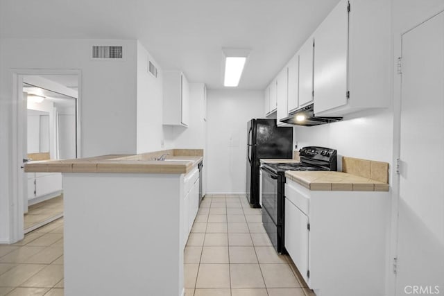 23515 Lyons Ave Unit 140, Valencia, CA 91355 - kitchen featuring black appliances, under cabinet range hood, light tile patterned flooring, a peninsula, and white cabinetry