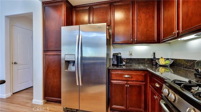 28653 Bar Hbr, Temecula, CA 92591 - kitchen with stainless steel appliances, reddish brown cabinets, light wood-style flooring, and dark stone countertops