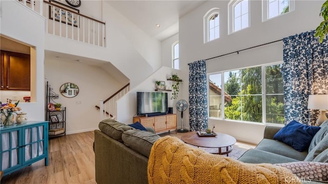 28653 Bar Hbr, Temecula, CA 92591 - living room with a towering ceiling, plenty of natural light, light wood finished floors, and stairs