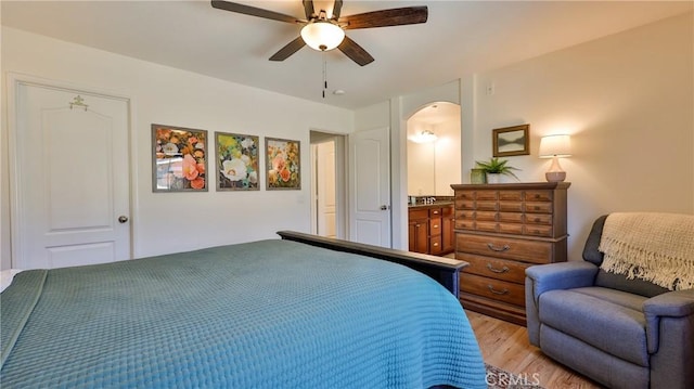 28653 Bar Hbr, Temecula, CA 92591 - bedroom with light wood-style floors, arched walkways, ceiling fan, and ensuite bathroom