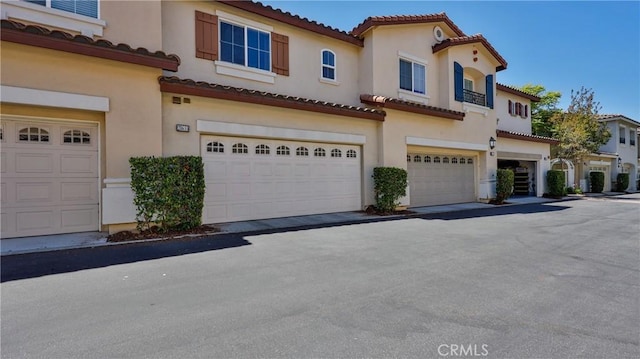 28653 Bar Hbr, Temecula, CA 92591 - view of front of house featuring a garage, a tiled roof, and stucco siding