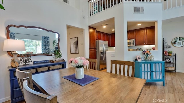 28653 Bar Hbr, Temecula, CA 92591 - dining area featuring light wood finished floors and a towering ceiling
