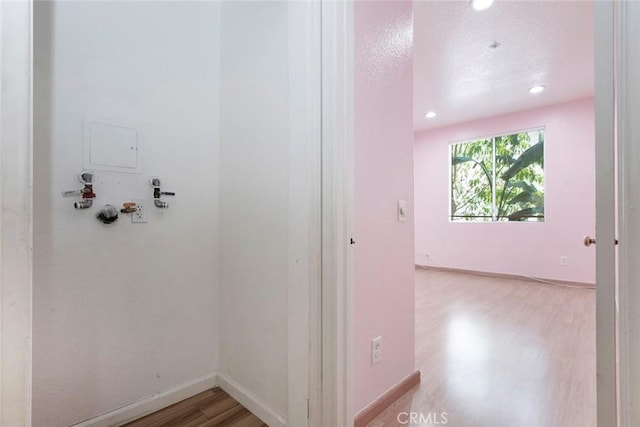 16940 Chatsworth St Unit 208, Granada Hills, CA 91344 - hallway featuring wood finished floors, recessed lighting, and a textured ceiling