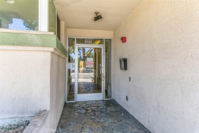 16940 Chatsworth St Unit 208, Granada Hills, CA 91344 - doorway to property featuring stucco siding