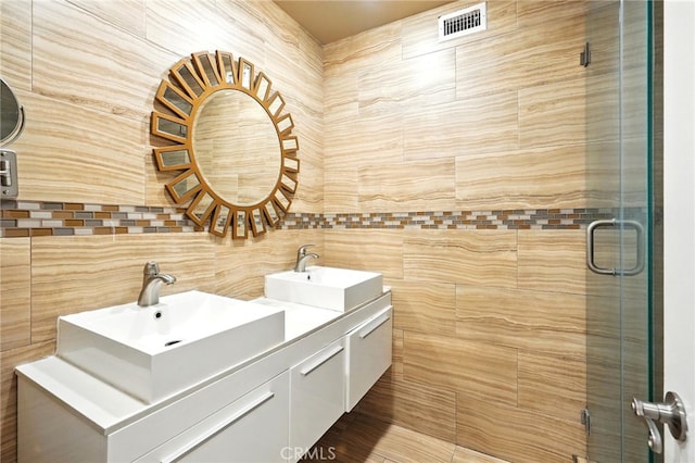 12720 Burbank Blvd Unit 121, Valley Village, CA 91607 - bathroom with double vanity, a stall shower, tile walls, and backsplash