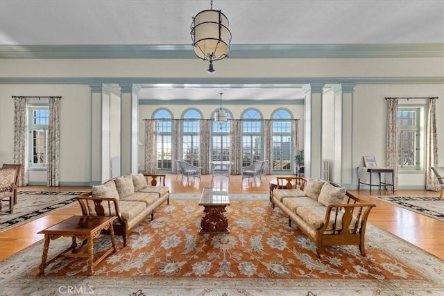 315 W 3rd St Unit 301, Long Beach, CA 90802 - living room featuring crown molding, plenty of natural light, wood finished floors, and decorative columns