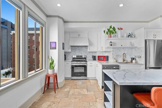 315 W 3rd St Unit 301, Long Beach, CA 90802 - kitchen featuring stainless steel appliances, open shelves, under cabinet range hood, decorative backsplash, and ornamental molding