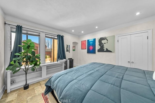 315 W 3rd St Unit 301, Long Beach, CA 90802 - bedroom with stone tile flooring, arched walkways, recessed lighting, and crown molding