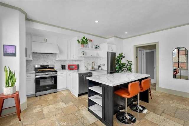 315 W 3rd St Unit 301, Long Beach, CA 90802 - kitchen with open shelves, under cabinet range hood, stainless steel appliances, stone tile flooring, and ornamental molding