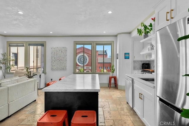 315 W 3rd St Unit 301, Long Beach, CA 90802 - kitchen with stainless steel appliances, stone tile floors, open shelves, recessed lighting, and white cabinetry