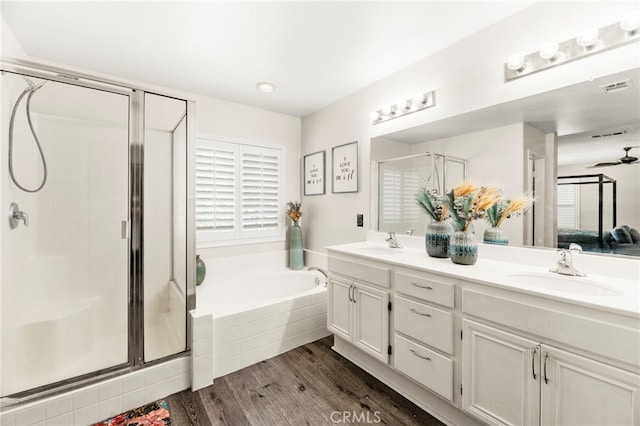 11209 Pinecone St, Corona, CA 92883 - bathroom with double vanity, a bath, a stall shower, and wood finished floors