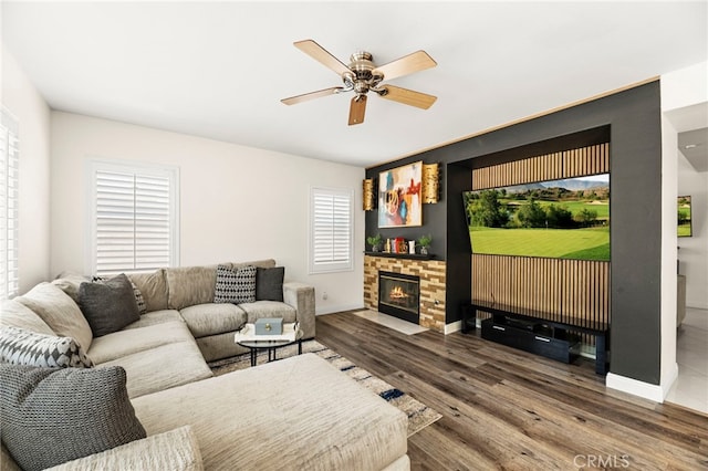 11209 Pinecone St, Corona, CA 92883 - living area featuring ceiling fan, wood finished floors, and a stone fireplace