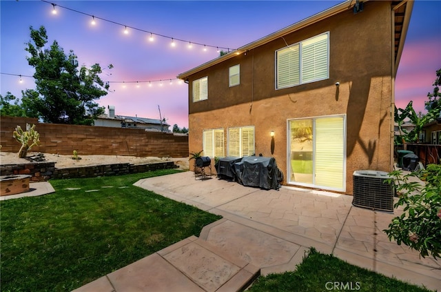 11209 Pinecone St, Corona, CA 92883 - back of house at dusk with a fenced backyard, stucco siding, and a patio