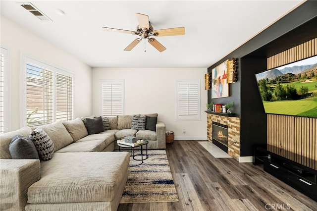 11209 Pinecone St, Corona, CA 92883 - living room with a ceiling fan, dark wood finished floors, and a fireplace with flush hearth