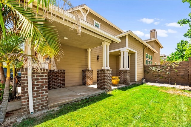 11209 Pinecone St, Corona, CA 92883 - property entrance featuring a chimney, a patio area, and brick siding