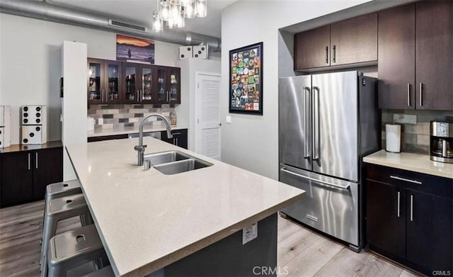 133 The Promenade N Unit 317, Long Beach, CA 90802 - kitchen with high end refrigerator, backsplash, light wood-style floors, and glass insert cabinets