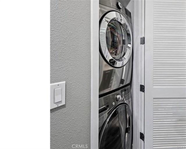 133 The Promenade N Unit 317, Long Beach, CA 90802 - washroom featuring stacked washing machine and dryer and a textured wall