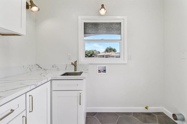 8450 Dallas St, La Mesa, CA 91942 - washroom with cabinet space, washer hookup, and dark tile patterned flooring