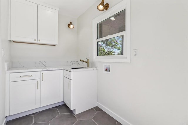 8450 Dallas St, La Mesa, CA 91942 - washroom with cabinet space, washer hookup, and dark tile patterned flooring