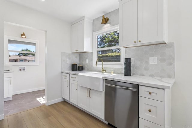 8450 Dallas St, La Mesa, CA 91942 - kitchen with stainless steel dishwasher, white cabinets, healthy amount of natural light, and light wood finished floors