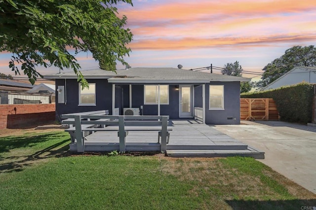 8450 Dallas St, La Mesa, CA 91942 - back of house at dusk with a shingled roof, a deck, and stucco siding