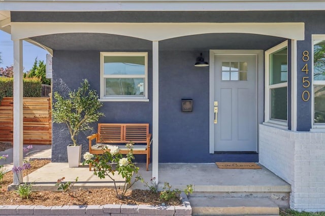 8450 Dallas St, La Mesa, CA 91942 - view of exterior entry with a porch and stucco siding